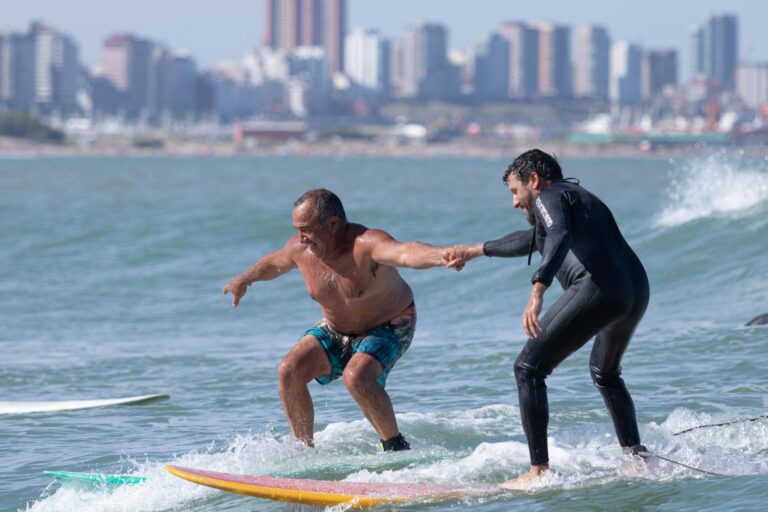 Two men surfing the waves together in Mar del Plata, Argentina.